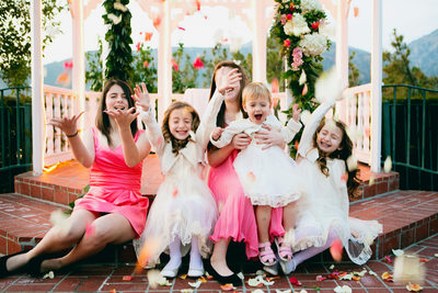 flower girls with rose petals in the air