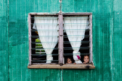Kids Look Out Window from House in Nomuka Tonga
