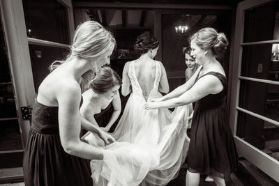Bridemaids Help Bride Into Her Gown At majestic Yosemite Hotel