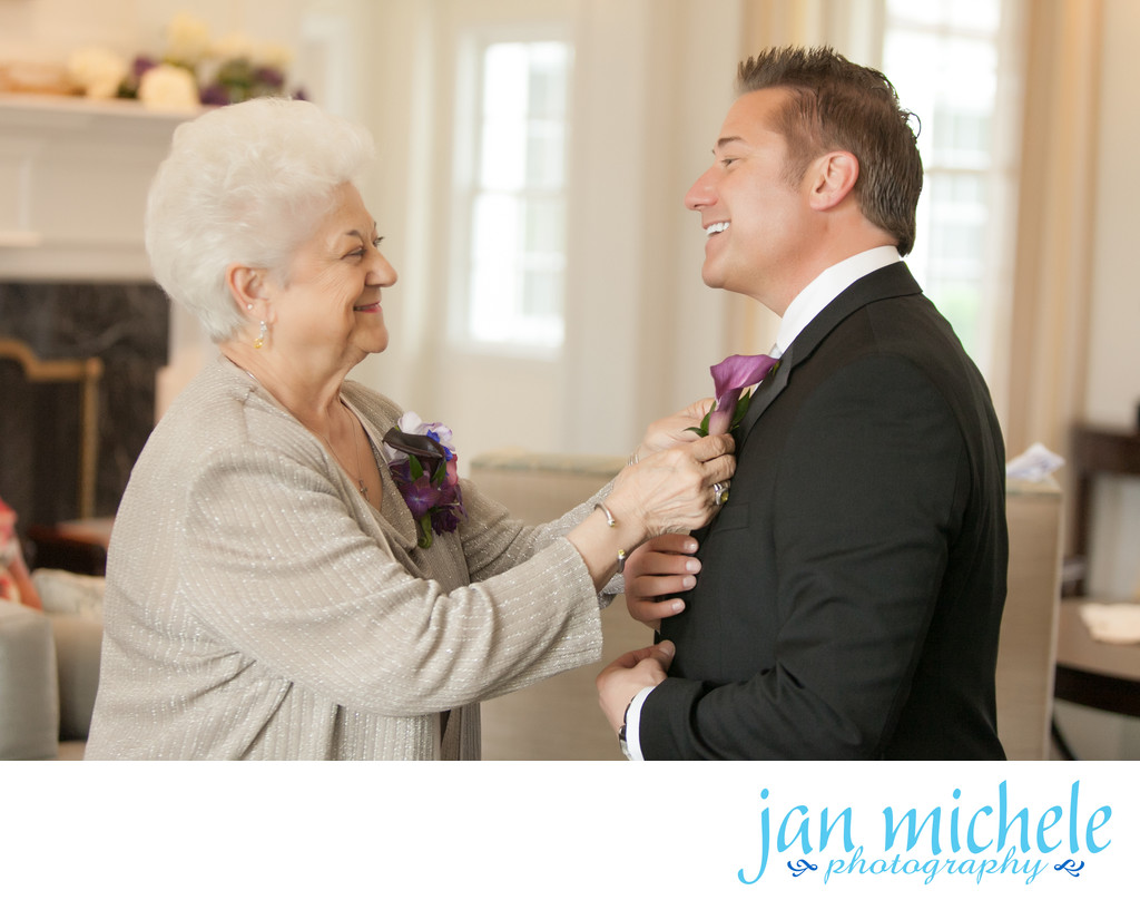 Mom pinning son's boutonnière on his wedding day