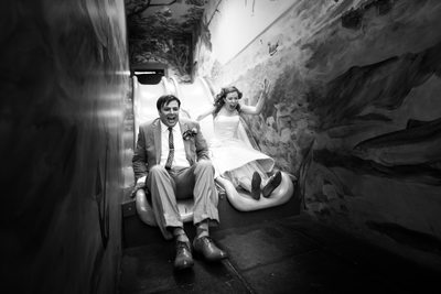 bride and groom on a slide at Urban Ecology Center
