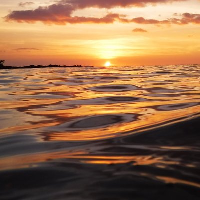 gorgeous ocean sunset with glossy reflective waves