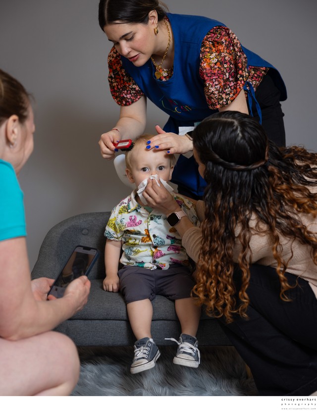 Teachers primp a student before his photo Teachers primp a student before his photo