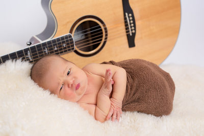 Newborn Photography - Baby in Front of Dad's Guitar