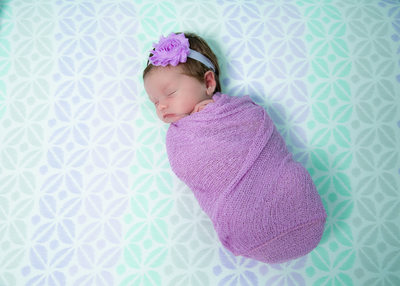 Swaddled Newborn in Crib, Purple and Teal