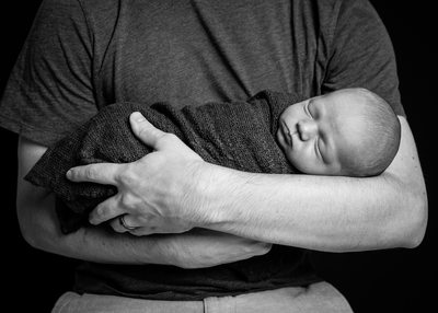 Newborn Baby Swaddled in Dad's Arms