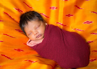Indian Newborn Boy Swaddled on Mom's Sari