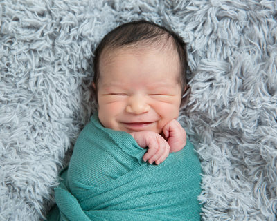 Smiling Swaddled Newborn Boy