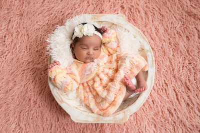 Infant Girl Asleep in Wooden Bowl, Pink