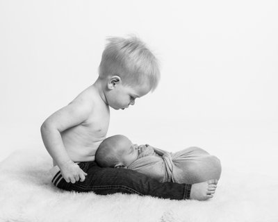 Toddler Holding Newborn Brother