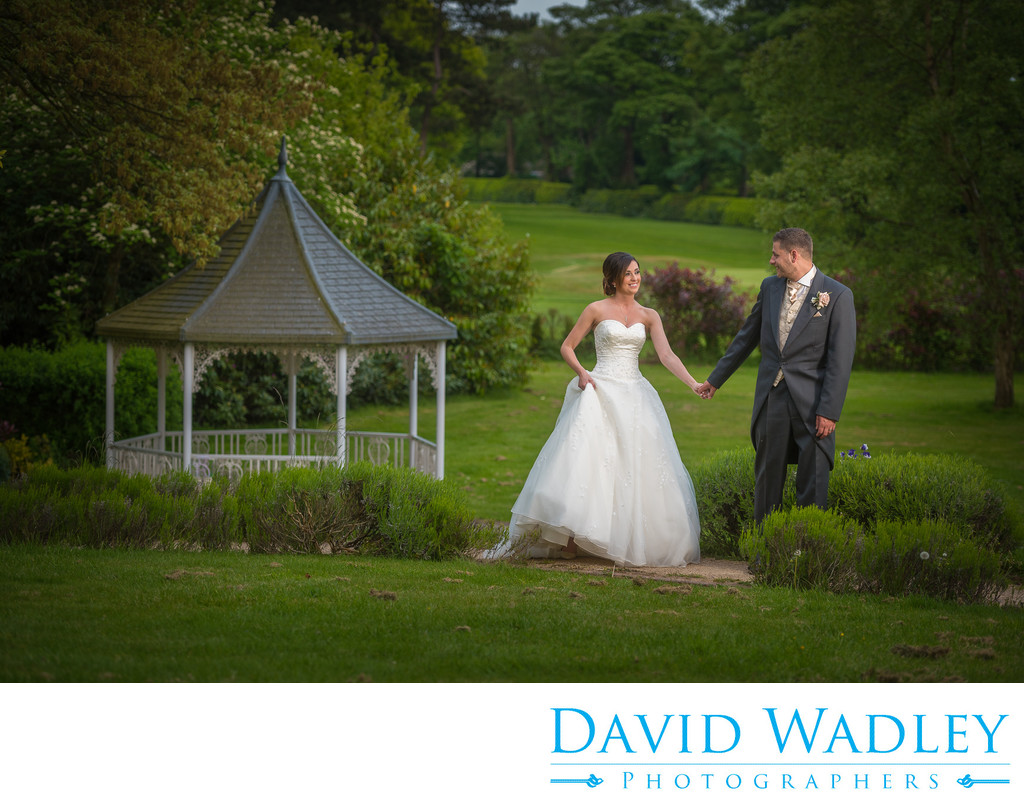 Wedding day photography, walking in the gardens at Moor Hall Hotel.