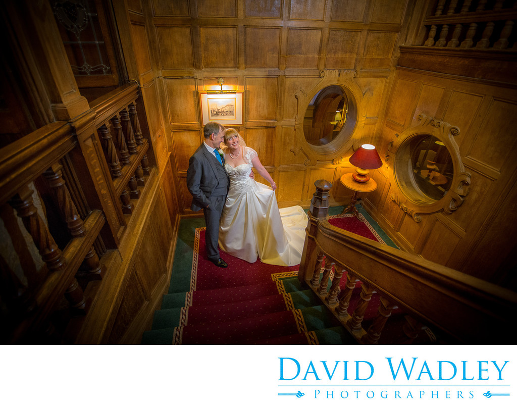 Wedding day photographed on staircase at Moor Hall Hotel.