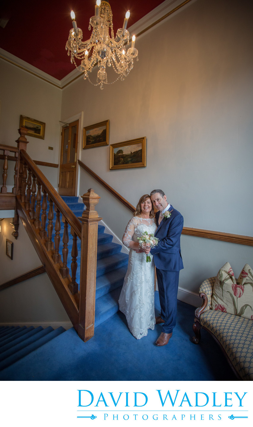 Bride & Groom on their wedding day on stairs at Grafton Manor.