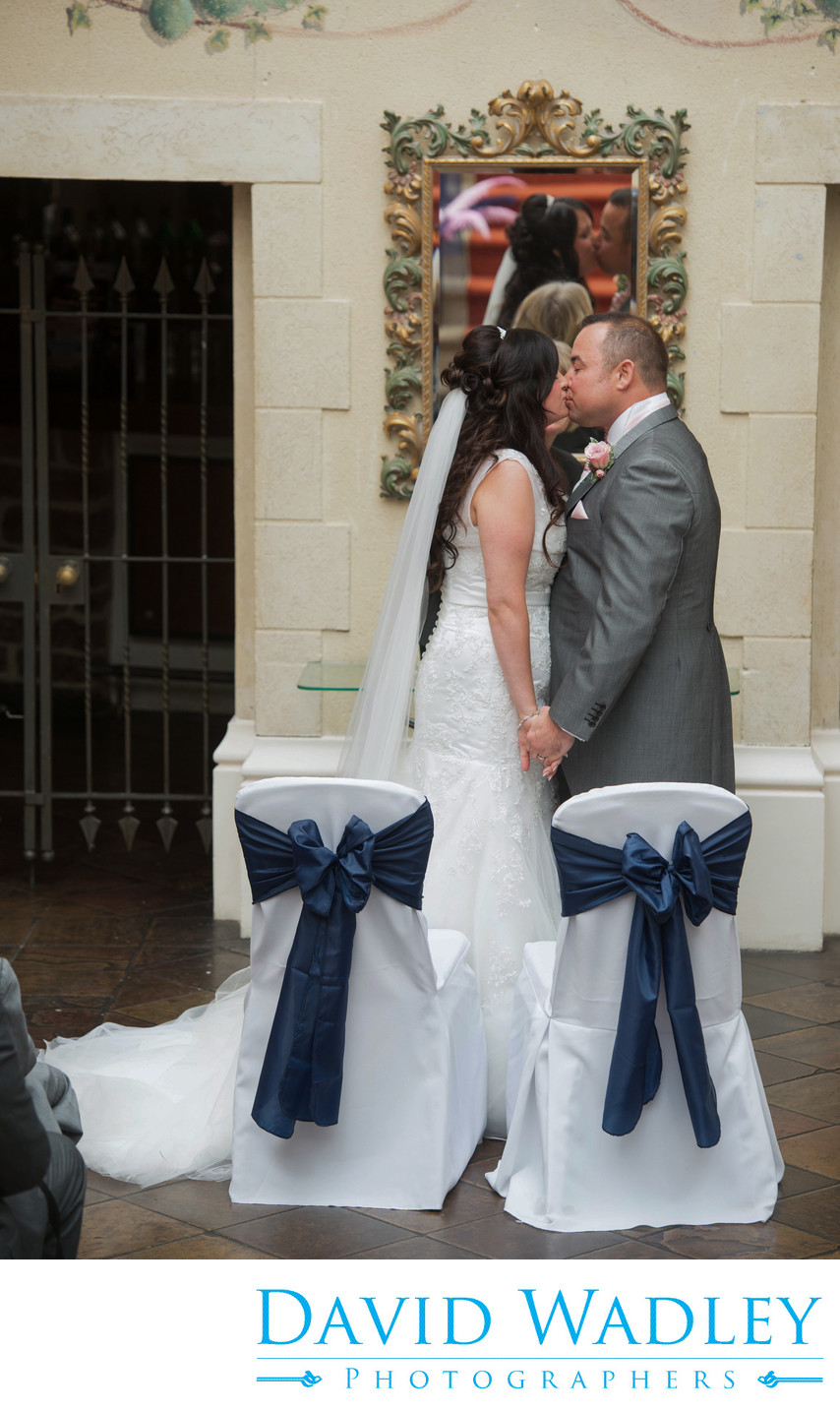 A kiss seals their wedding at Nailcote Hall.