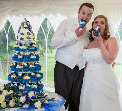 Eating cupcakes  at Grafton Manor on their wedding day.