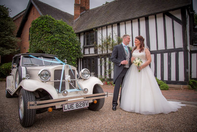 Wedding car with bride & Groom outside Nailcote Hall