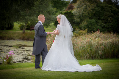 Bride & Groom talking in the grounds of Nailcote Hall.