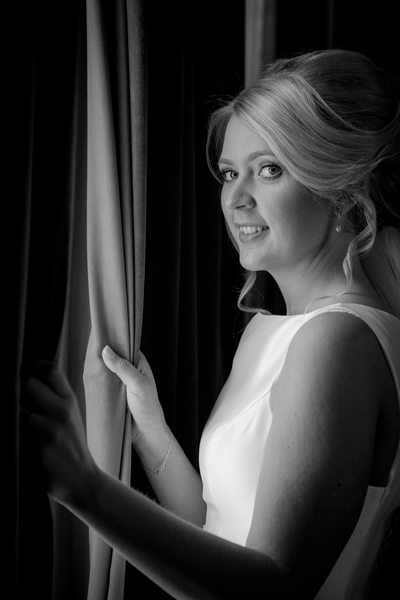 Bride looking out on her wedding day at Grafton Manor Hotel Bromsgrove.