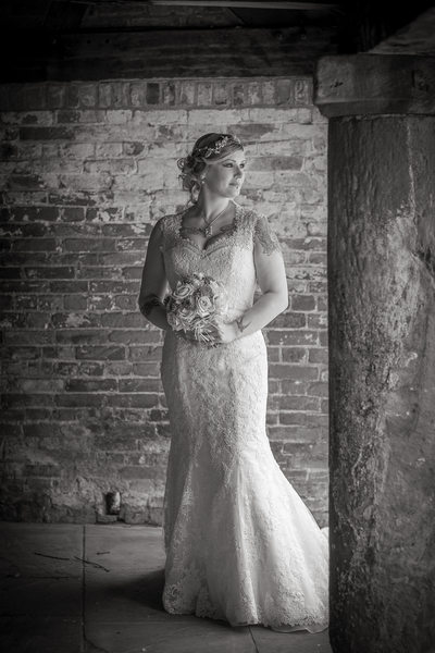 Bride in the courtyard of Shustoke Barn.
