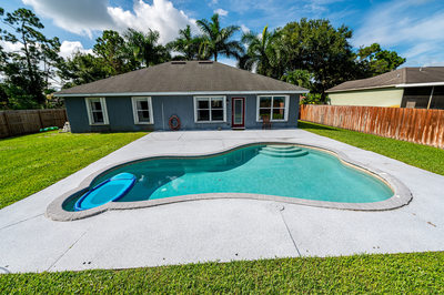 Outdoor real estate photo showing pool home in Florida