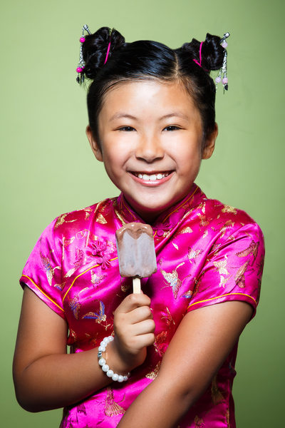 Smiling girl eating popsicle