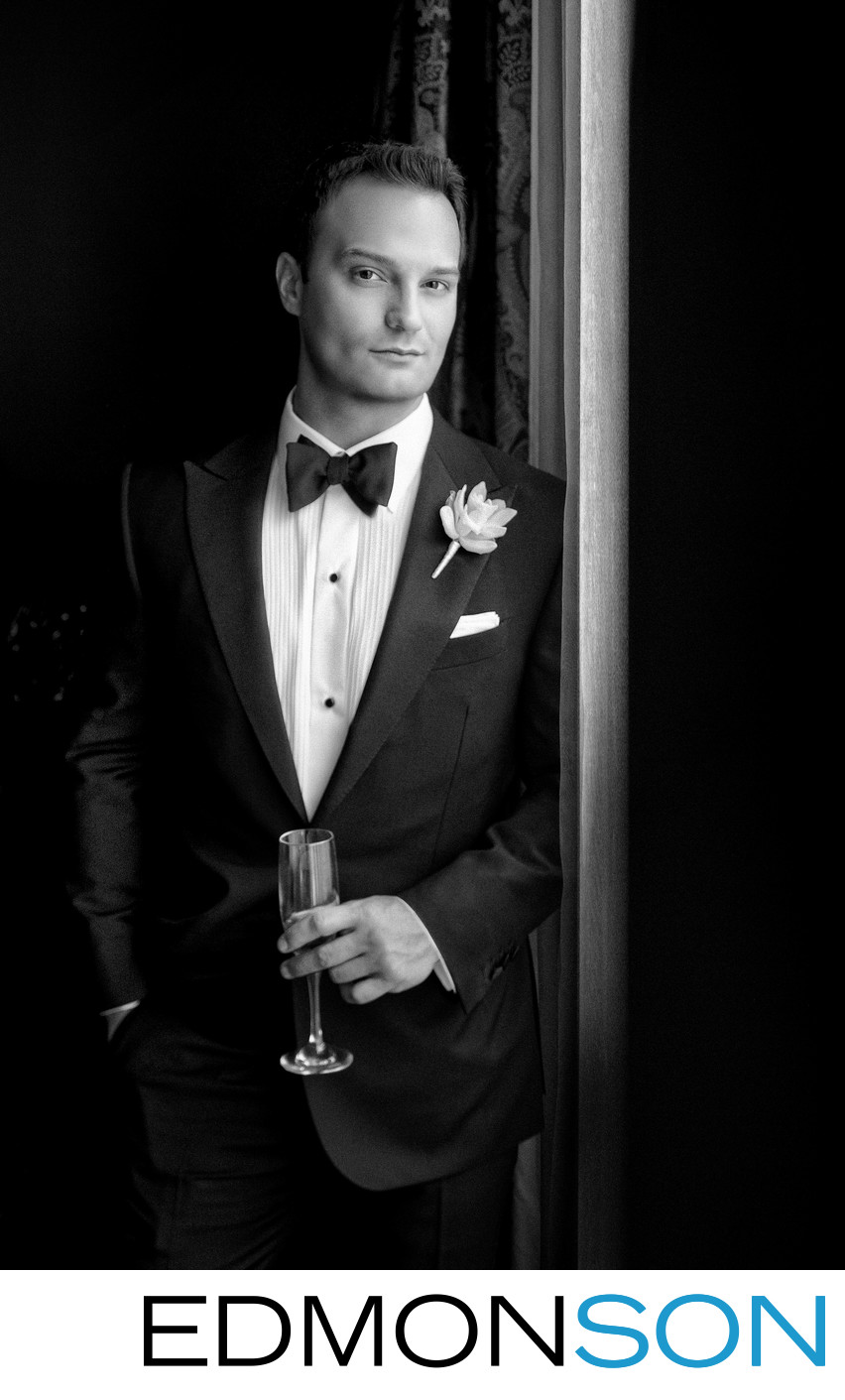 Black And White Groom Holds Glass In Portrait