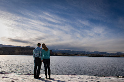 Couple watching winter sunset at Fort Collins engagement