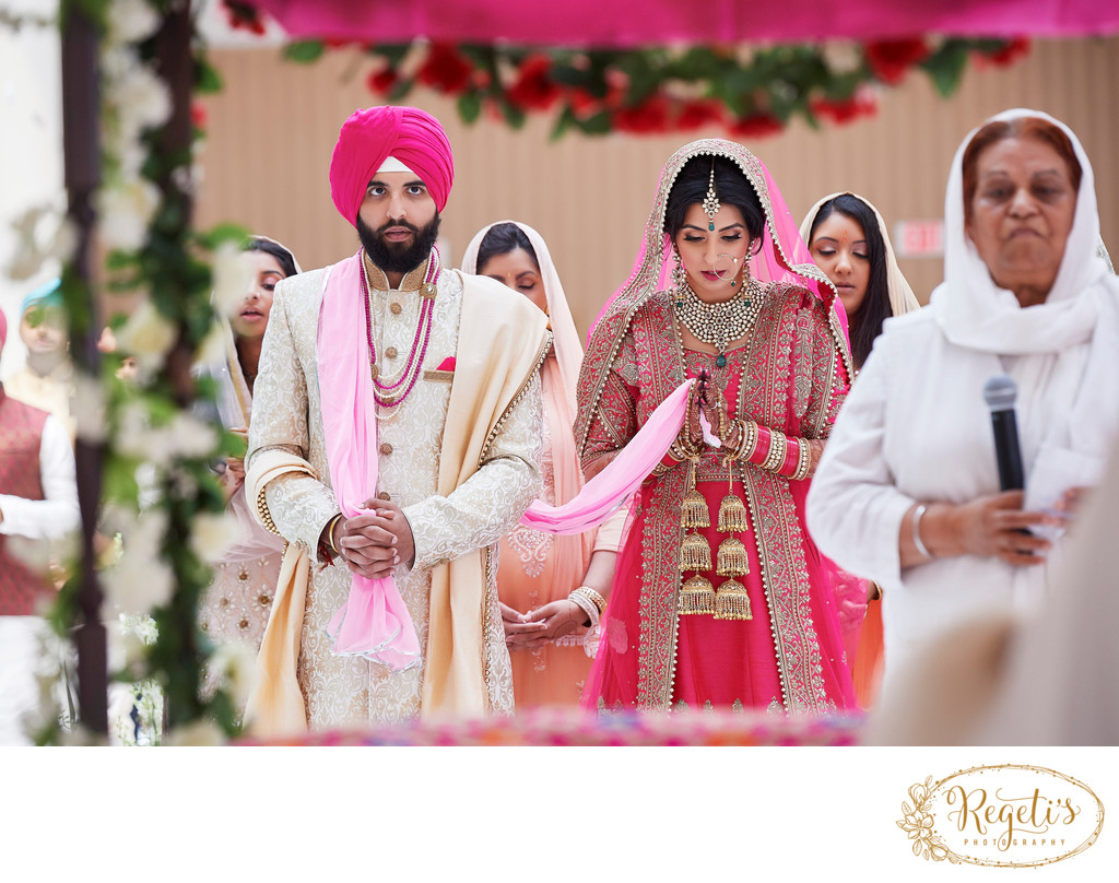 Sikh bride and groom praying 