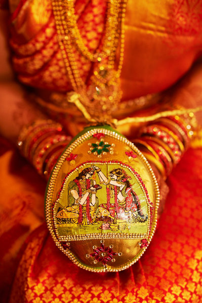 Telugu bride holding a decorated coconut