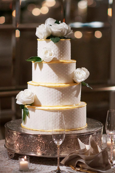 Cream Dot Gold Wedding Cake Accented with White Roses