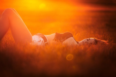 Laying in field during sunset