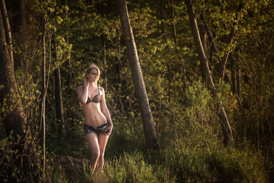 Blonde woman posing in forest