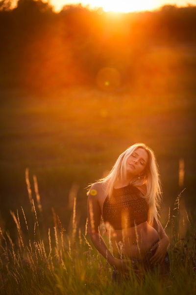 Girl in field at sunset