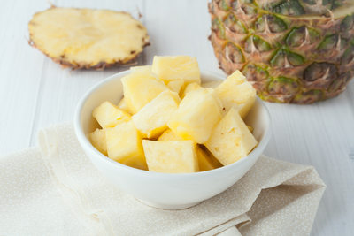 pineapple chunks in white bowl