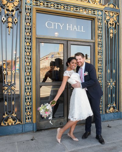 Bride and Groom hug outside of San Francisco city hall
