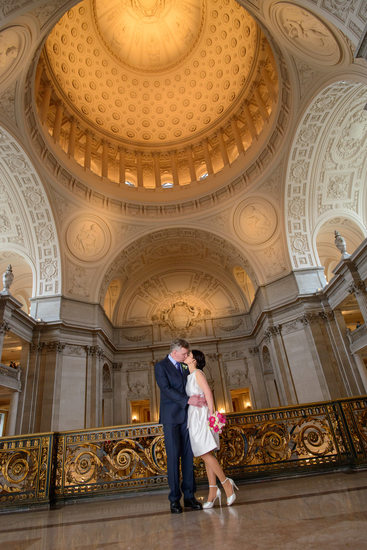 San Francisco City Hall Wedding Photographers -  bride and groom posing under the dome