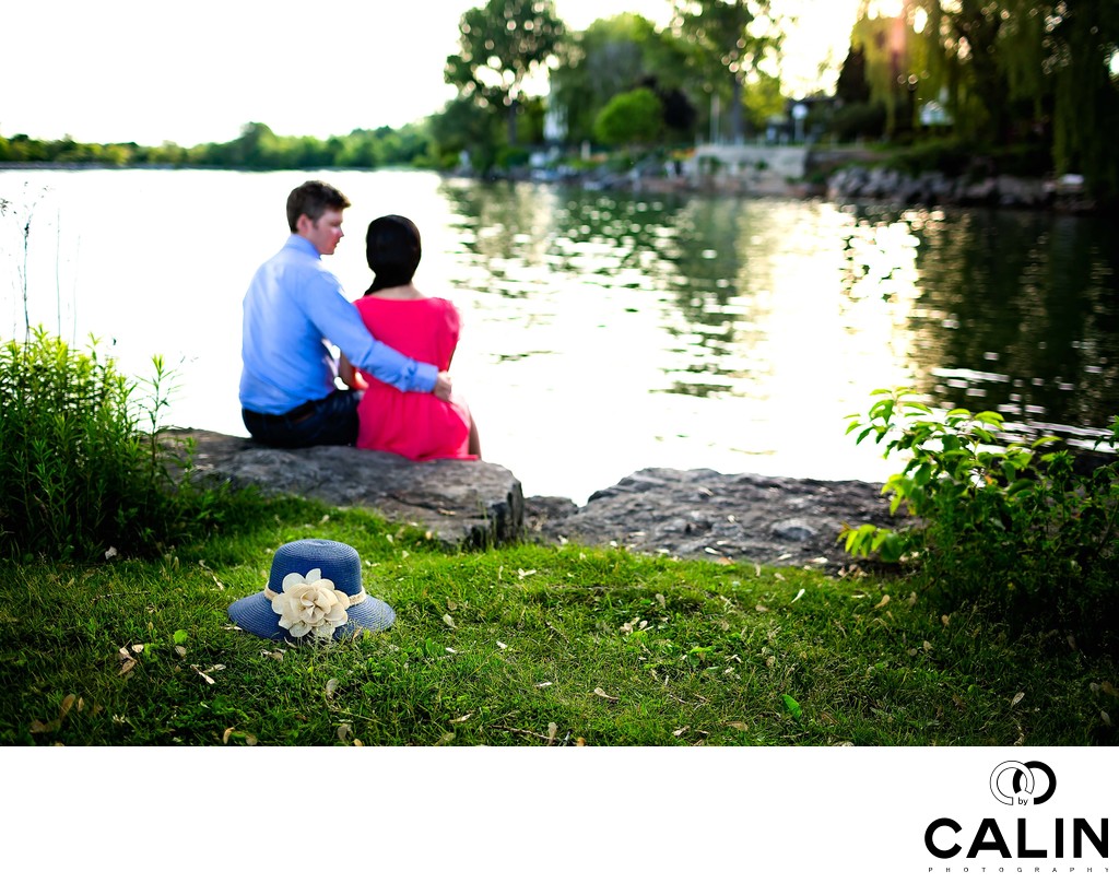 Engaged Photo of Couple Sitting by Lake Ontario