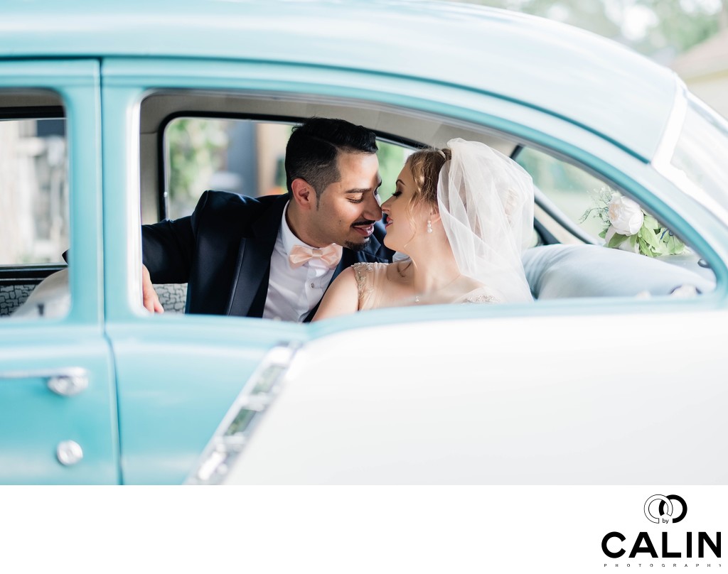 Bride and Groom Kiss in a Retro Car