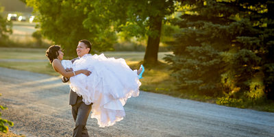 Groom Carries Bride at Country Heritage Park Wedding