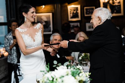 Bride Receives a Gift at Storys Building Wedding