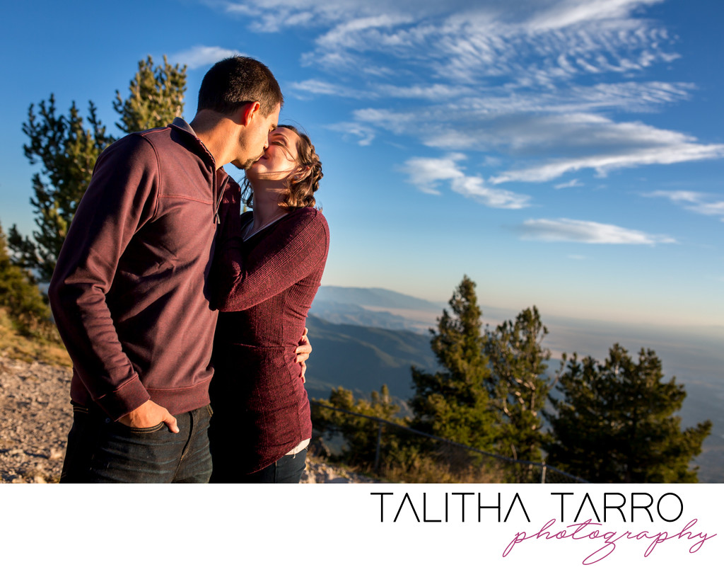 couple kissing on top of the mountain