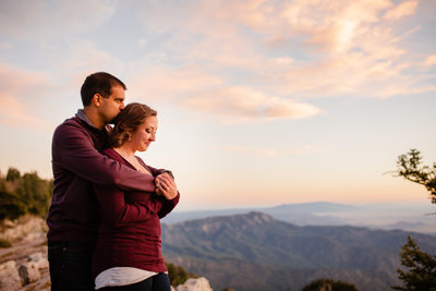 Couple hugging each other at the crest of the mountain