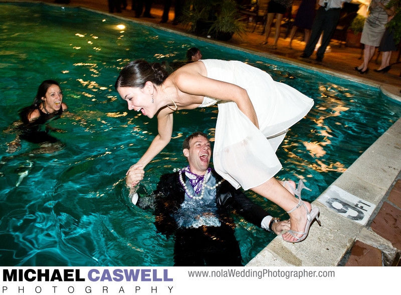 Groom pulls bride into pool