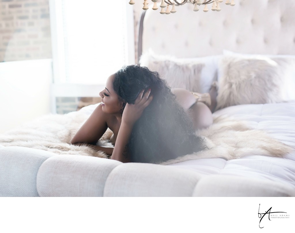 Lifestyle boudoir photography in bedroom setting