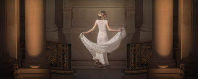 Elegant Lace Wedding Dress & Grand Pillars in Warm Light