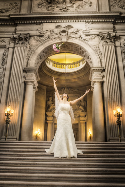 bride with bouquet atop of grand staircase