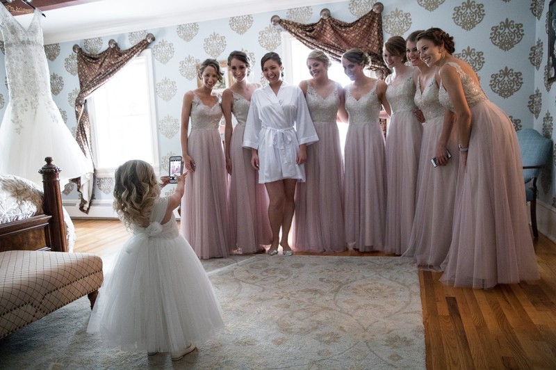 Flower girl and bridesmaids in wedding getting room