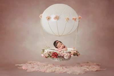 Newborn girl in hot air balloon