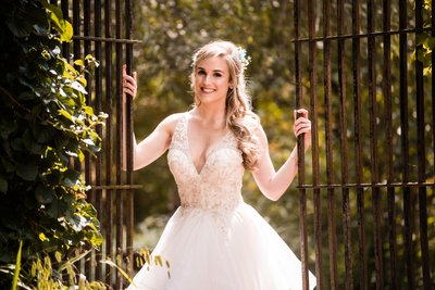 Bride by Gate at Holly Hedge