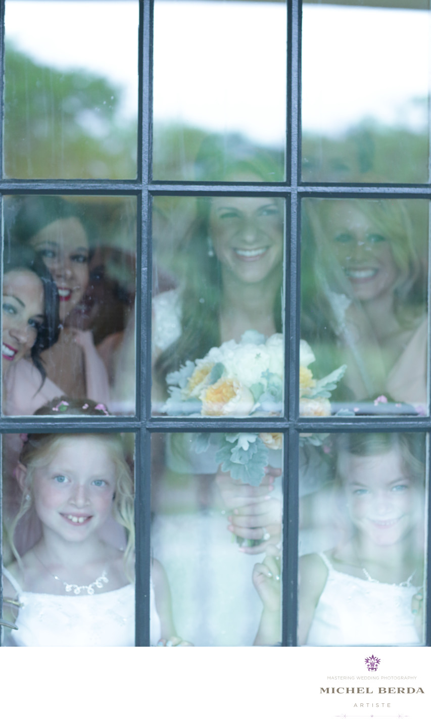 Looking through the glass door bride and bridemaids Dunes West Golf & River Club